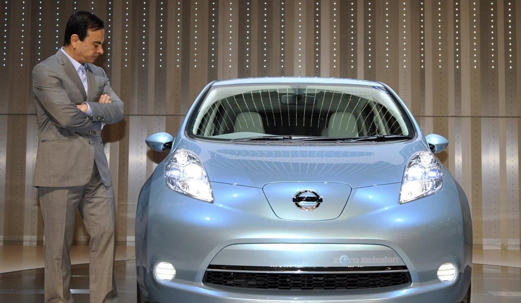 Ghosn pictured with the Nissan Leaf in 2009. Photo: EPA