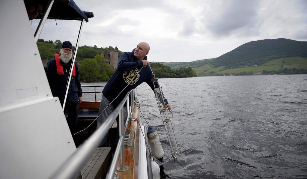 Professor Neil Gemmell taking samples on his boat on Loch Ness on June 11, 2018. Photo: AFP