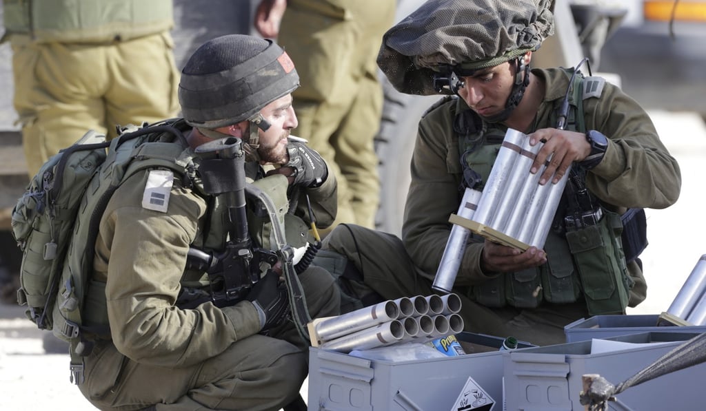 Israeli soldiers reload canisters for a gas grenade launcher during a Palestinian protest near the border fence between Gaza and Israel. Photo: EPA Israeli soldiers reload canisters for a gas grenade launcher during a Palestinian protest near the border fence between Gaza and Israel. Photo: EPA