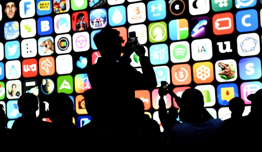 Attendees taking photographs with mobile devices before the start of the Apple Worldwide Developers Conference in San Jose, California, on June 4. Photo: Bloomberg