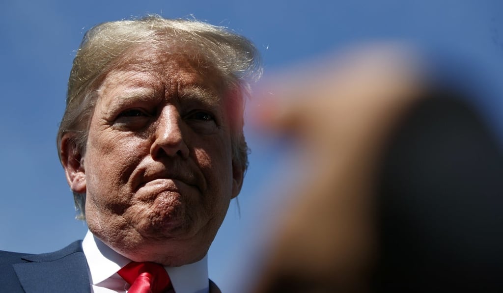 President Donald Trump listens to a question from reporters on the North Lawn of the White House on Friday. Photo: AP