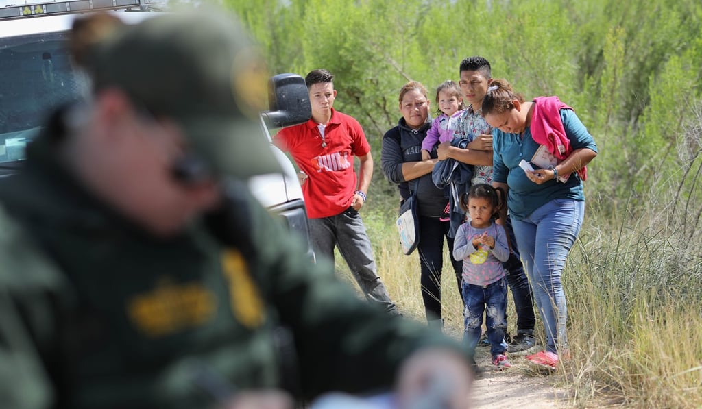 Central American asylum seekers wait as a US Border Patrol agents take groups of them into custody on Tuesday near McAllen, Texas. Photo: AFP Central American asylum seekers wait as a US Border Patrol agents take groups of them into custody on Tuesday near McAllen, Texas. Photo: AFP