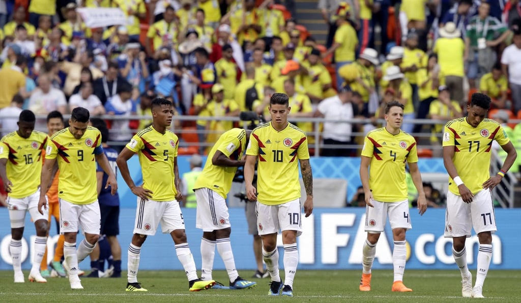 Colombia's James Rodriguez (10) and his teammates walk off the pitch. Photo: AP