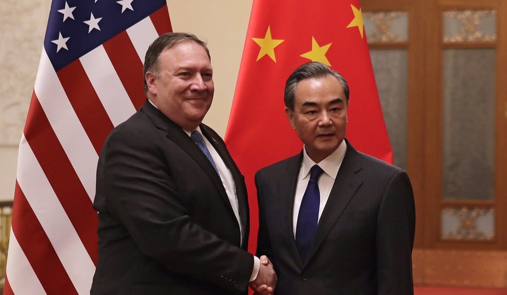 Pompeo shakes hands with Chinese Foreign Minister Wang Yi as they pose for photograph at the Great Hall of the People in Beijing on Thursday. Photo: AP