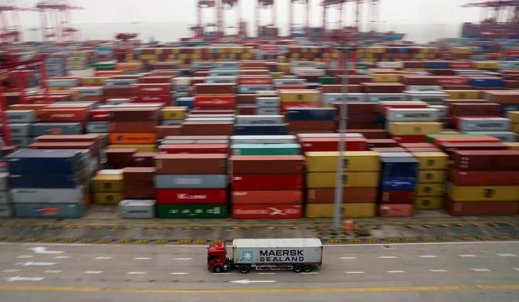 A container truck moves past containers at the Yangshan Deep Water Port in Shanghai. Photo: Reuters