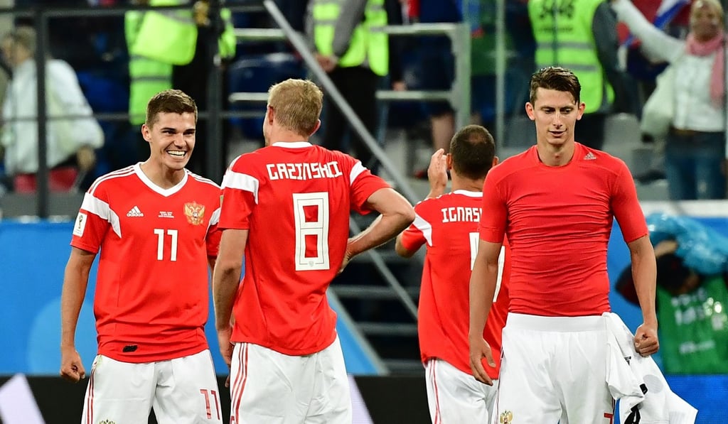 Russia's midfielder Roman Zobnin (L), Russia's midfielder Yuri Gazinskiy and Russia's defender Ilja Kutepov (R) celebrate. Photo: AFP Russia's midfielder Roman Zobnin (L), Russia's midfielder Yuri Gazinskiy and Russia's defender Ilja Kutepov (R) celebrate. Photo: AFP