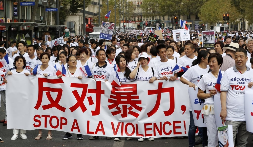 Members of the Chinese community in France hold a banner during a demonstration calling for greater security measures on September 4, 2016 in Paris, following the death of Zhang Chaolin. Photo: AFP