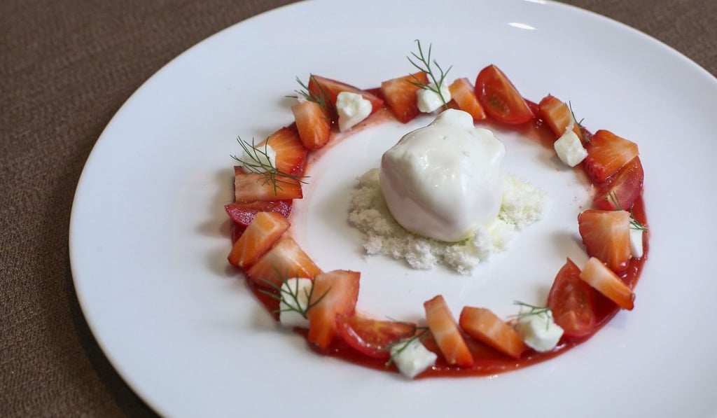 Buffala buratta with ‘fleur de sel’ amao strawberries, amela rubins cherry tomatoes and bronze fennel, at Amber. Photo: Edmond So