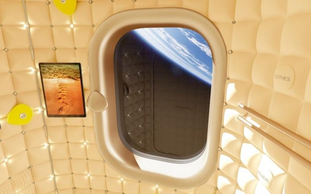 The space station’s interior includes metallic gold-framed windows and gold textile covers on handles that people will use to pull themselves around the space station.
