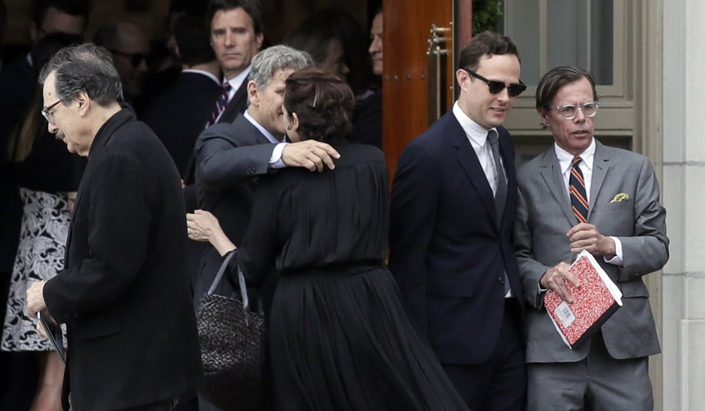 Andy Spade, far right, leaves his wife's funeral service at Our Lady of Perpetual Help Catholic Church in Kansas City on Thursday. Photo: AP