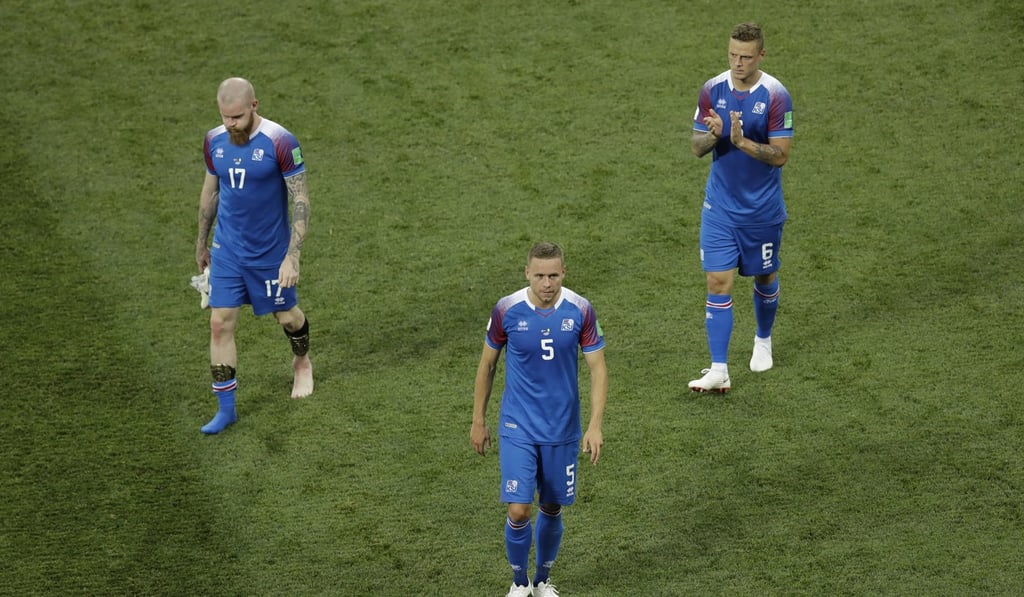 Iceland's Aron Gunnarsson, Sverrir Ingason and Ragnar Sigurdsson applaud their fans after losing. Photo: AP