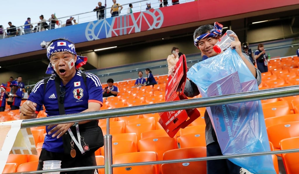 Japanese fans clean up after themselves in Ekaterinburg Arena, Yekaterinburg, after their team’s draw with Senegal. Photo: Reuters