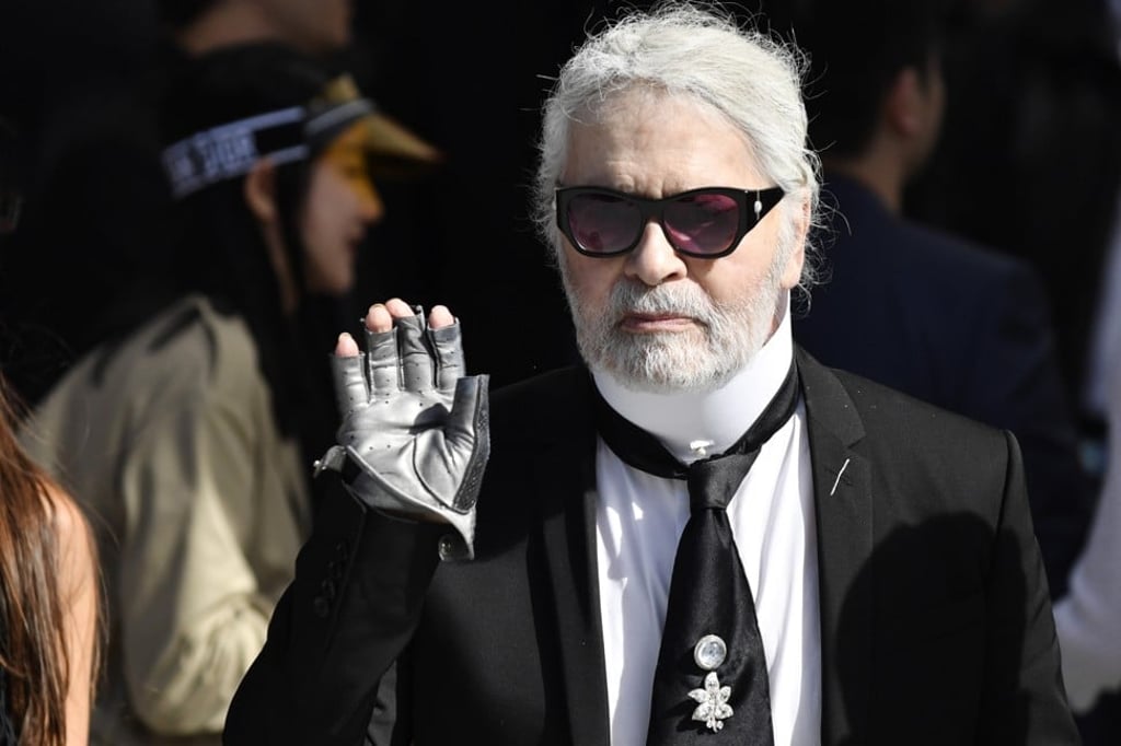 Chanel’s head creative designer Karl Lagerfeld waves to photographers as he arrives at Kim Jones’ debut Dior Homme show at Paris Men’s Fashion Week on Saturday. Photo: EPA-EFE