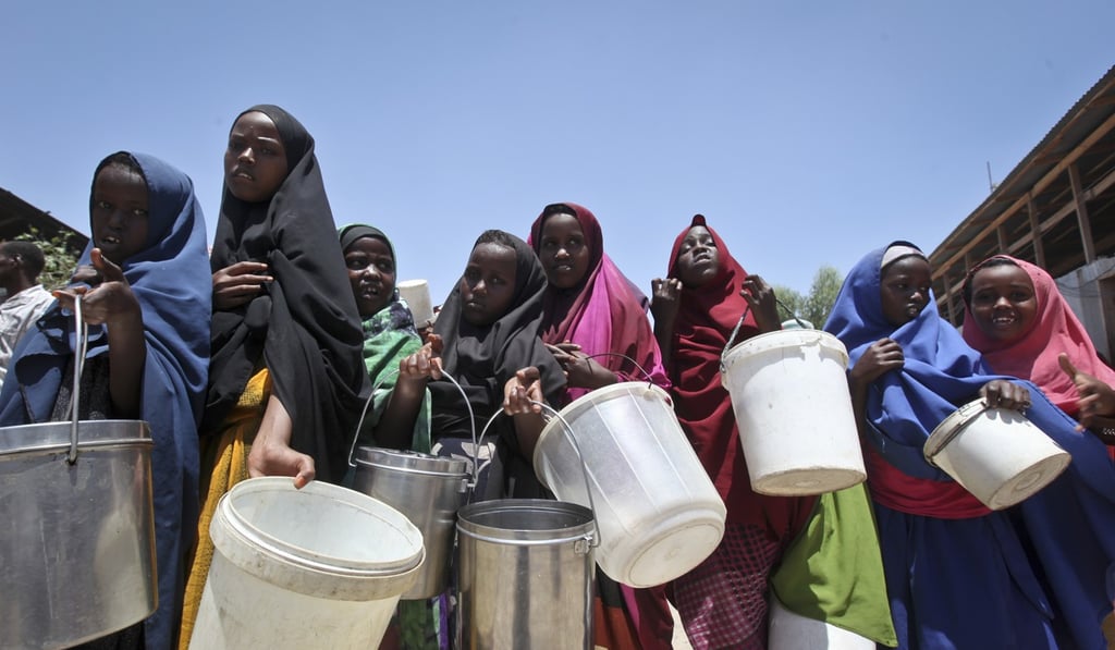 Displaced Somali girls who fled the drought in southern Somalia stand in a queue to receive food handouts at a centre in Mogadishu, in February 2017. Photo: AP