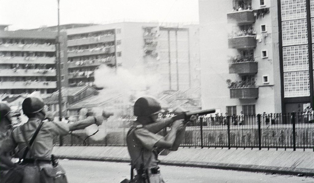 A police riot squad units firing tear gas shells to disperse thousands of demonstrators outside the Tung Tau resettlement estate. Photo: Robin Lam