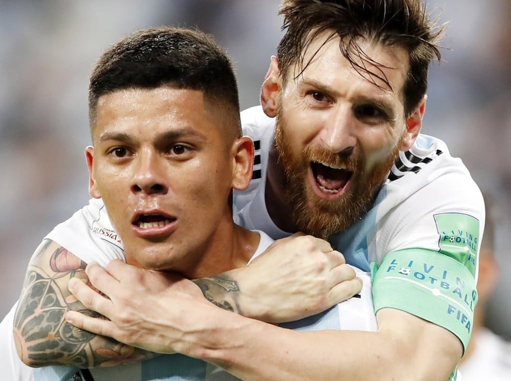 Marcos Rojo celebrates his late winner with Messi. Photo: EPA