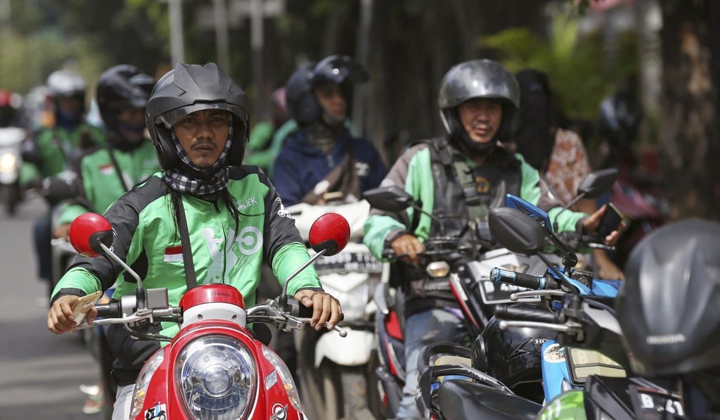 Go-Jek drivers wait for customers in Jakarta on May 24. The Indonesian ride-hailing app says it will expand into Thailand, Vietnam, Singapore and the Philippines in the next few months. Photo: AP