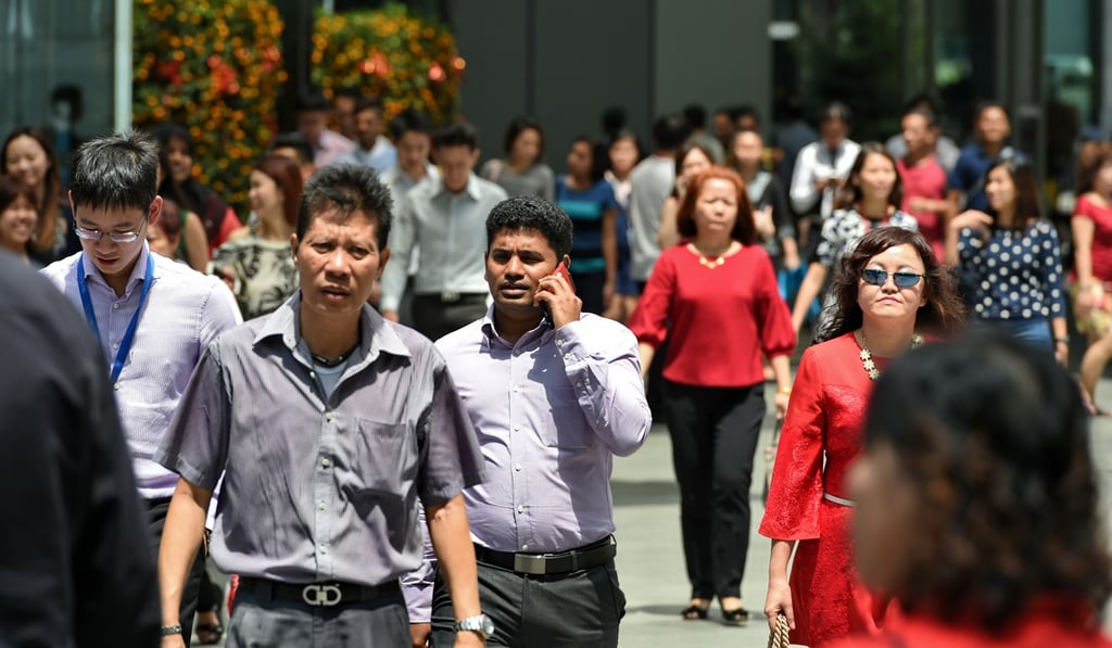 Workers out during lunch time in the financial business district in Singapore, in 2015. Singapore has proactive policies for encouraging older employees to keep working. Photo: AFP