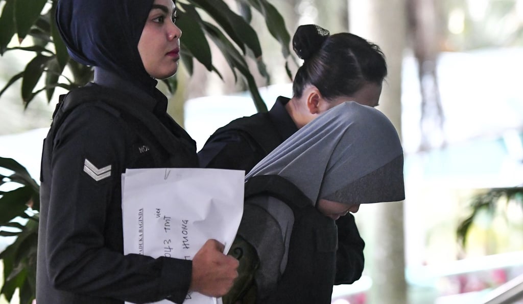 Indonesian Siti Aisyah, centre, is escorted by police to court. Photo: AP Indonesian Siti Aisyah, centre, is escorted by police to court. Photo: AP