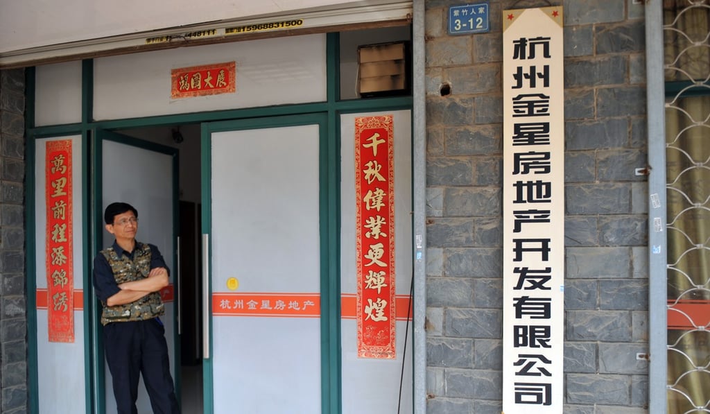 A staff member stands at Glory real estate company in Hangzhou, the capital city of Zhejiang province. Photo: Xinhua