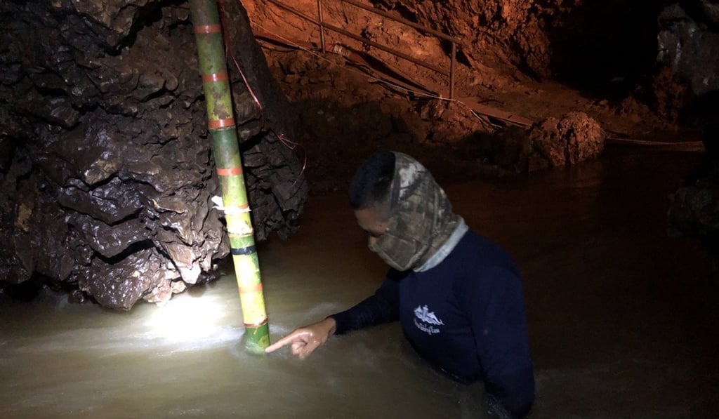 A Thai Navy official checks the height of the water inside the cave as they prepare to drain water. Photo: EPA A Thai Navy official checks the height of the water inside the cave as they prepare to drain water. Photo: EPA