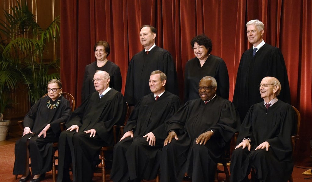 Members of the US Supreme Court pose for a group photograph at the Supreme Court building on June 1, 2017, in Washington. Front row, seated from left, Associate Justice Ruth Bader Ginsburg, Associate Justice Anthony M. Kennedy, Chief Justice of the United States John G. Roberts, Associate Justice Clarence Thomas, and Associate Justice Stephen Breyer. Standing behind from left, Associate Justice Elena Kagan, Associate Justice Samuel Alito Jnr, Associate Justice Sonia Sotomayor, and Associate Justice Neil Gorsuch. Photo: TNS