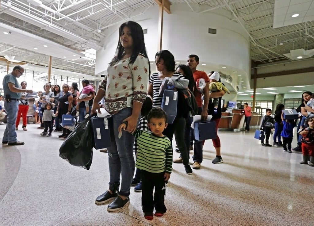 Migrant families are processed before being taken to Catholic Charities in Texas on Tuesday. Photo: EPA-EFE