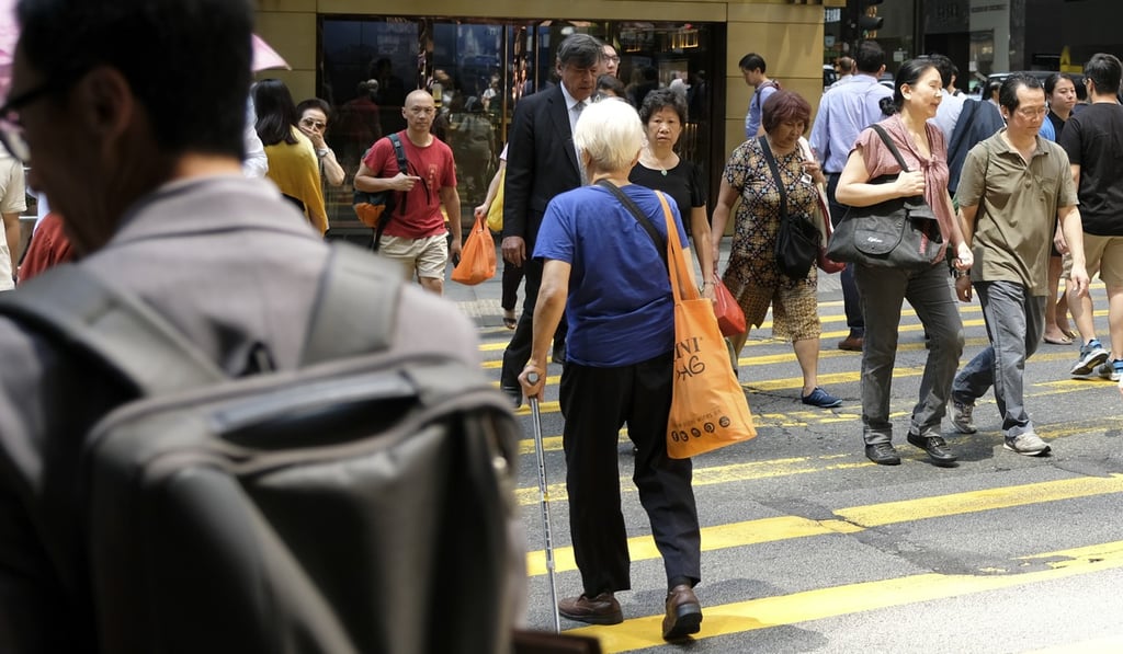 An elderly woman crosses a road in the Central district of Hong Kong on May 18. The MPF’s Default Investment Strategy is designed to reduce risk as the investor gets older. Photo: Fung Chang
