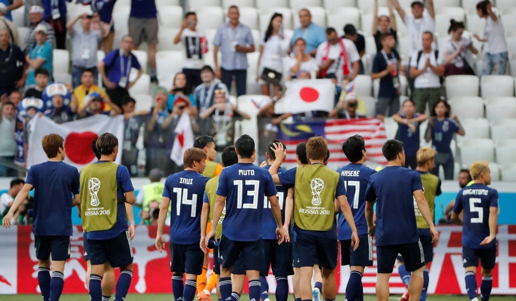 Japan greet their fans after they salvage their World Cup campaign. Photo: Reuters