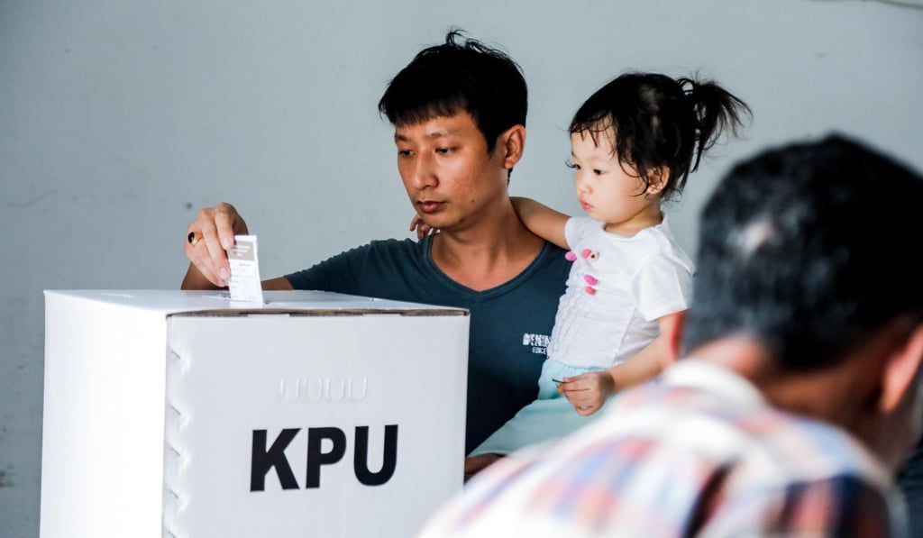 Indonesians cast their votes at a polling station in Medan. Photo: EPA
