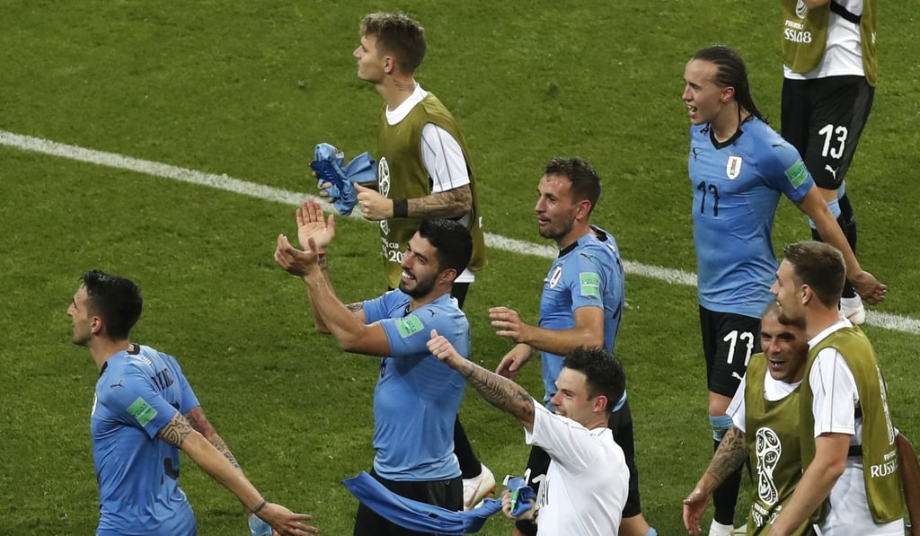 Uruguay players celebrate after advancing to the quarter-finals of the World Cup. Photo: AP