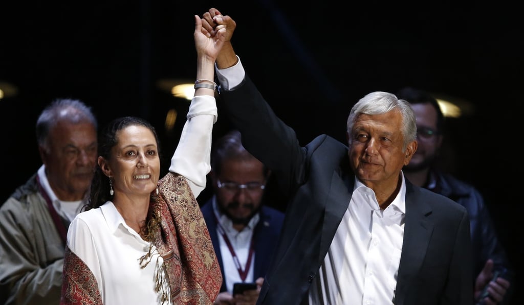 Presidential candidate Andres Manuel Lopez Obrador, of the MORENA party, right, and Mexico City mayoral candidate Claudia Sheinbaum hold their closing campaign rally at Azteca stadium in Mexico City on Wednesday. Photo: AP
