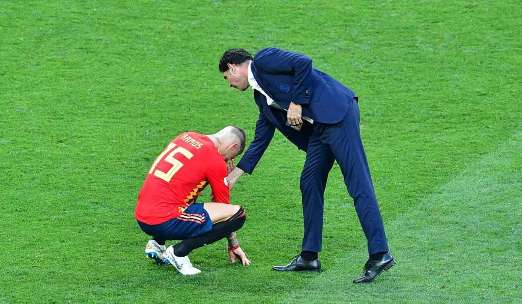 Spain defender Sergio Ramos is consoled by Fernando Hierro react after the loss to Russia. Photo: AFP