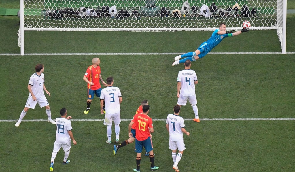 Russia goalkeeper Igor Akinfeev dives for the ball during the World Cup round of 16 match against Spain. Photo: AFP