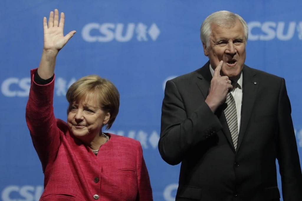 Angel Merkel is seen with Seehofer in Munich in September last year. Photo: AP