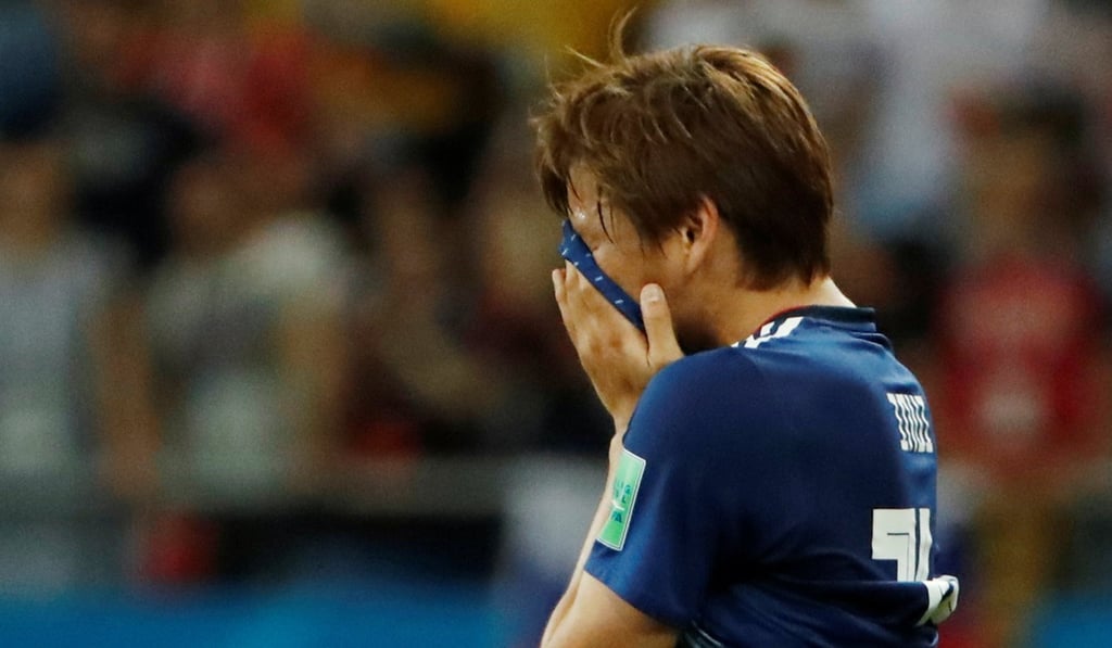 Heartbroken Takashi Inui looks dejected after Japan are beaten by Belgium. Photo: Reuters