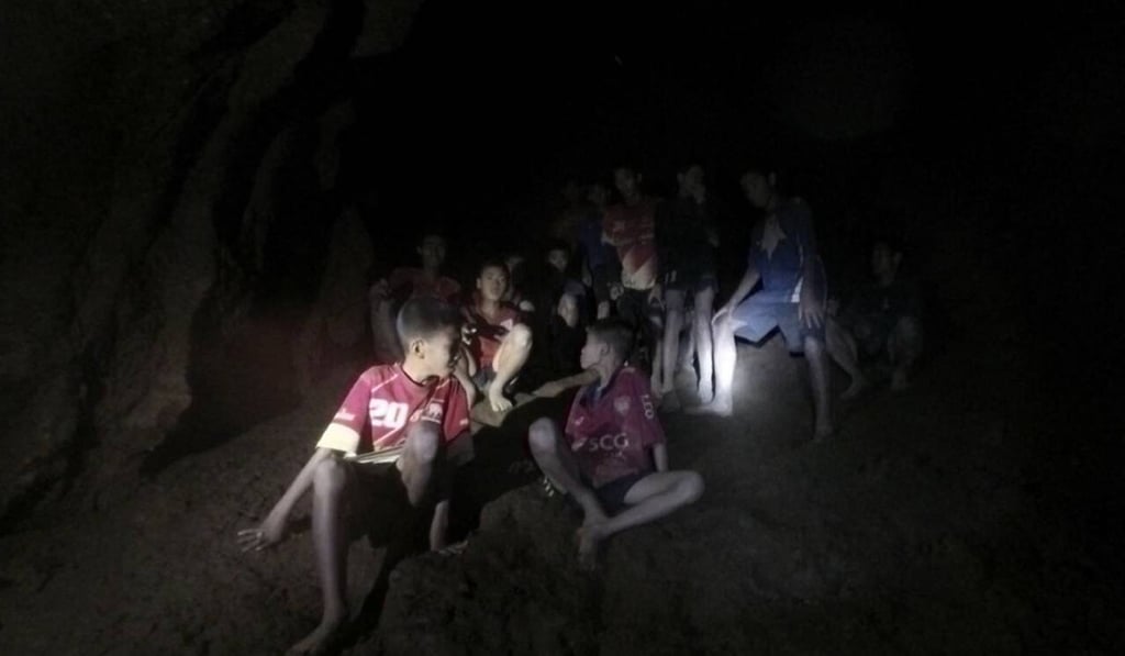 A photo taken by rescuers in the Tham Luang cave complex shows 12 young members of a soccer team and their coach, moments they were found. Photo: EPA A photo taken by rescuers in the Tham Luang cave complex shows 12 young members of a soccer team and their coach, moments they were found. Photo: EPA