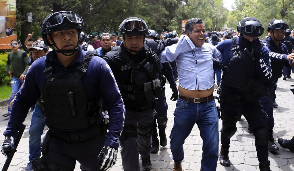 A man is arrested after supporters of presidential candidate Andres Manuel Lopez Obrador. Photo: EPA A man is arrested after supporters of presidential candidate Andres Manuel Lopez Obrador. Photo: EPA