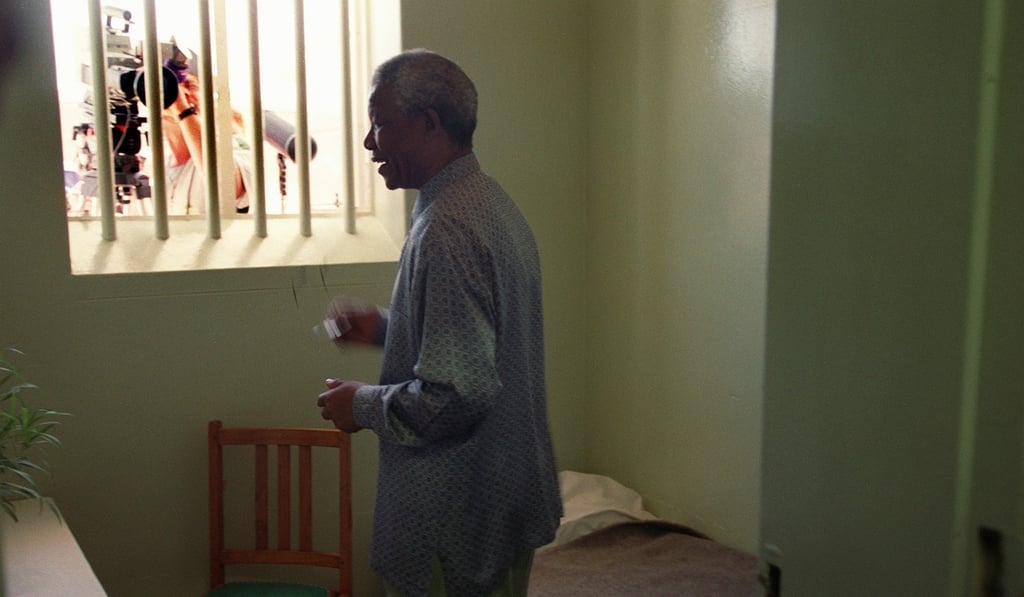 Late South African president Nelson Mandela visits his former cell in notorious Robben Island prison off the coast of Cape Town in 1995. Photo: Agence France-Presse