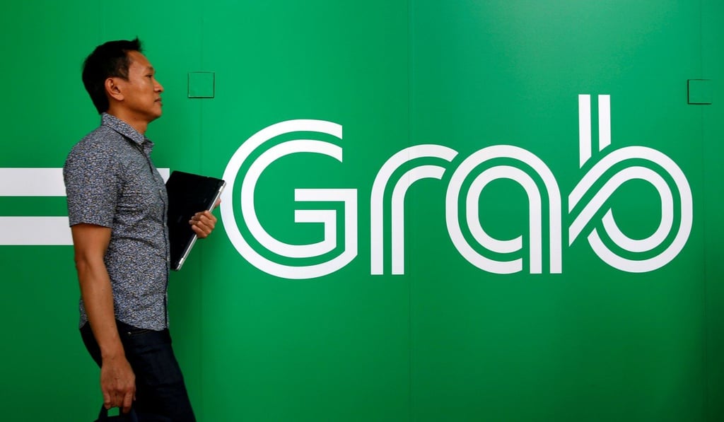 A man passes a Grab sign at their office in Singapore September 23, 2016. REUTERS