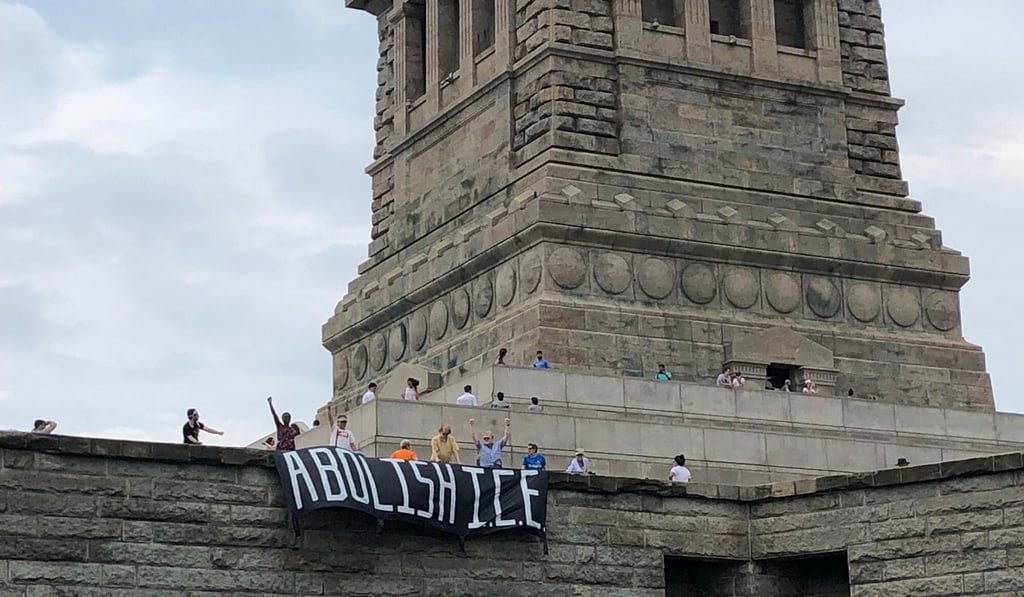 The group Rise and Resist stage a protest at the Statue of Liberty in New York. Photo: Reuters