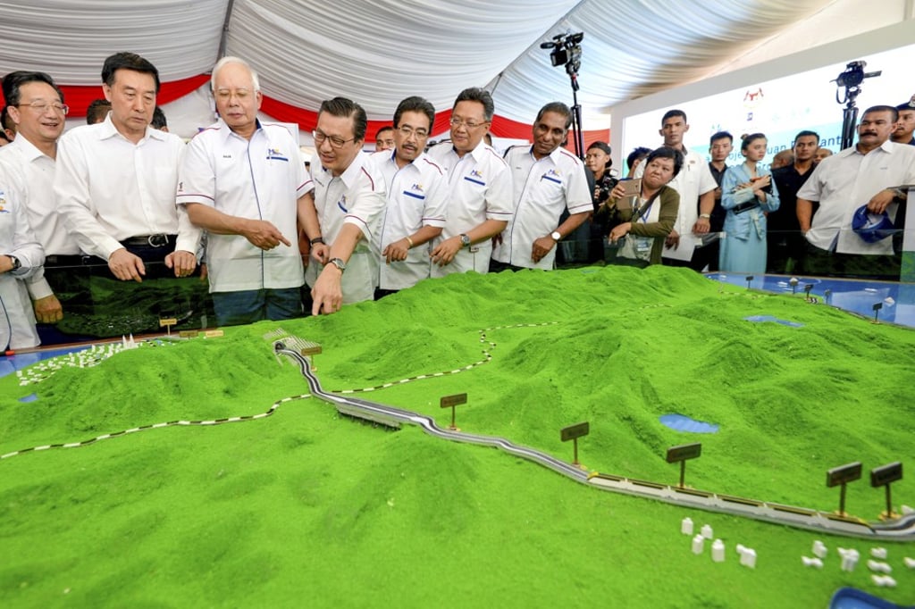 Najib Razak (third from left), then the prime minister of Malaysia, looks at a model of the East Coast Rail Link during the project’s launch in September last year. AP Photo