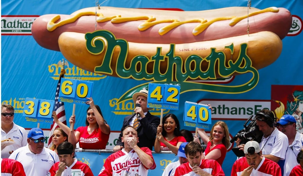 Joey Chestnut (centre) competes in the annual Nathan's Hot Dog Eating Contest on July 4. Photo: Agence France-Presse