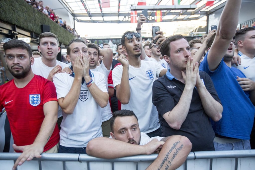 England fans watch in London as Harry Kane prepares to take a penalty. Photo: EPA