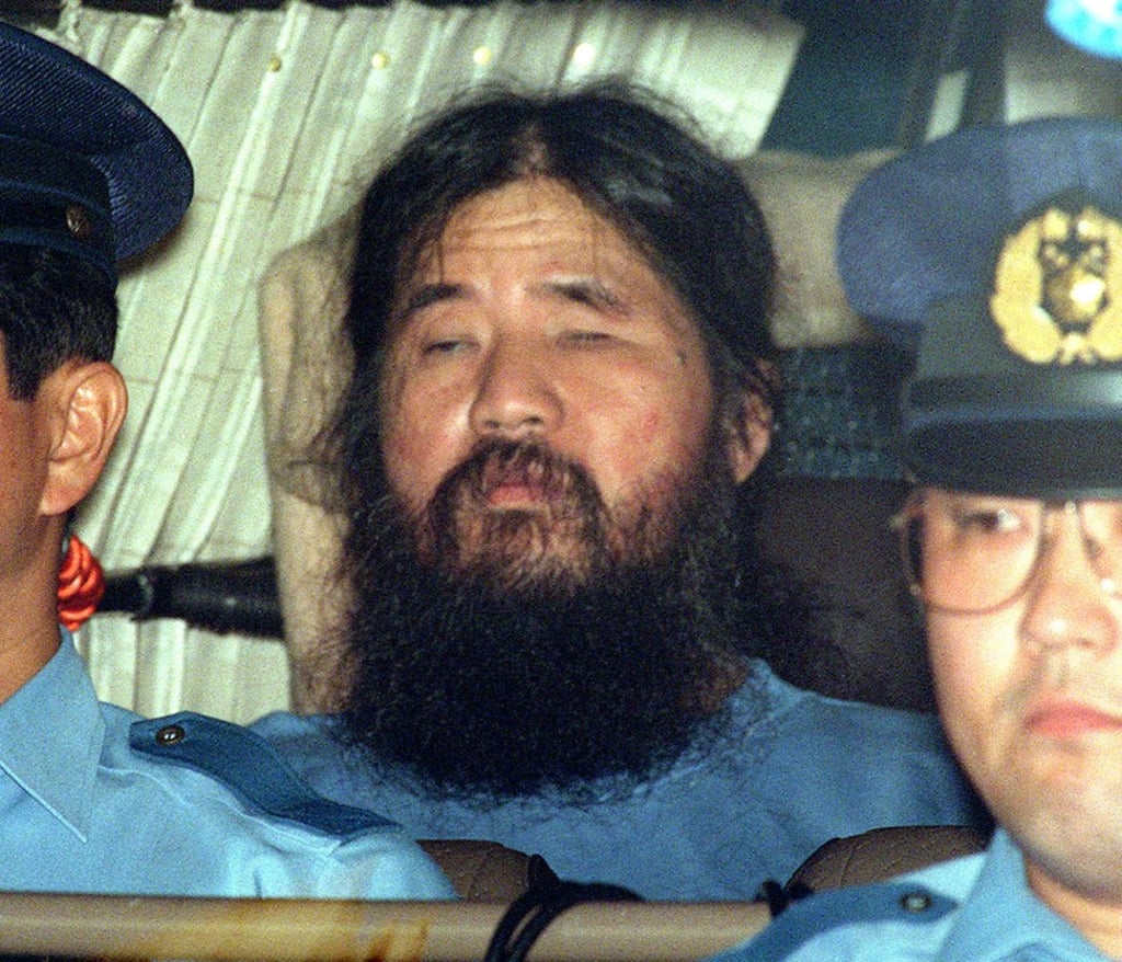 Shoko Asahara is transported by police in September 1995. Picture: AP Photo/Kyodo News
