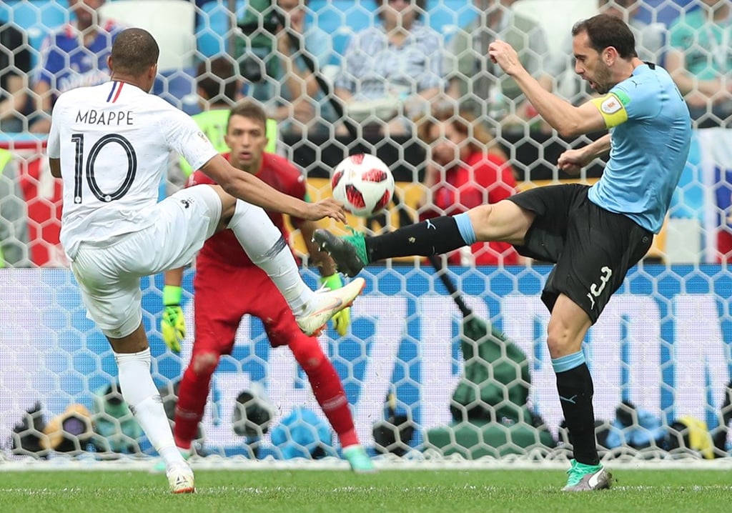 Kylian Mbappe (left) challenges with Uruguay’s Diego Godin in a fiery World Cup quarter-final clash. Photo: EPA Kylian Mbappe (left) challenges with Uruguay’s Diego Godin in a fiery World Cup quarter-final clash. Photo: EPA