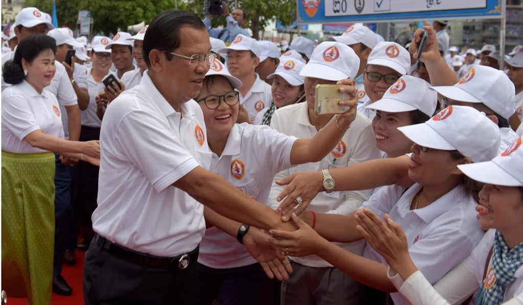 Hun Sen and his wife Bun Rany greeting supporters at the rally. Photo: AFP Hun Sen and his wife Bun Rany greeting supporters at the rally. Photo: AFP