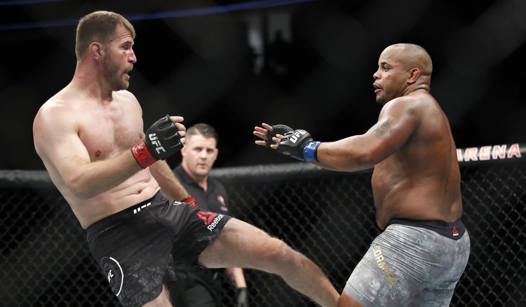 Stipe Miocic kicks Daniel Cormier during their heavyweight title fight. Photo: AP