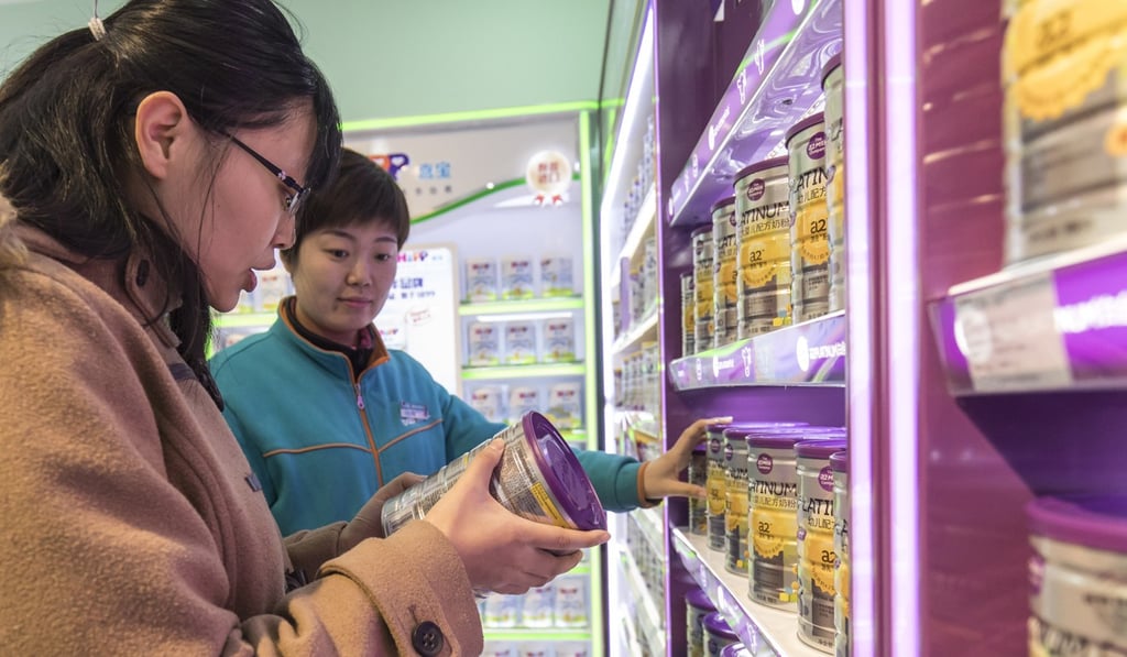 A customer with a can of baby milk formula in Shanghai in 2017. The industry is worth about US$70 billion annually. Photo: Bloomberg