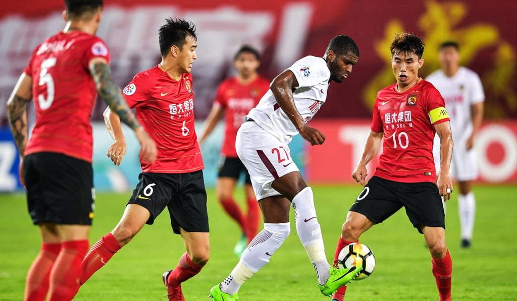 Tianjin Quanjian’s Anthony Modeste fights for the ball against Guangzhou Evergrande. Photo: AFP